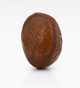 An antique carved nut vesta, finely decorated with Australian themes including kangaroos and emus, horse and rider, etc, circa 1880, 4.2cm high