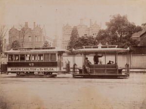 MELBOURNE STREET CARS & TRAMS: A group of three albumen paper photographs including a striking image of the North Carlton & St Kilda cable-car passing the Queen Victoria Hospital in Lonsdale Street and another view of Russell Street before paving and tram