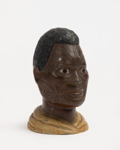 An antique painted spelter bust of a Maori, circa 1900, 9cm high