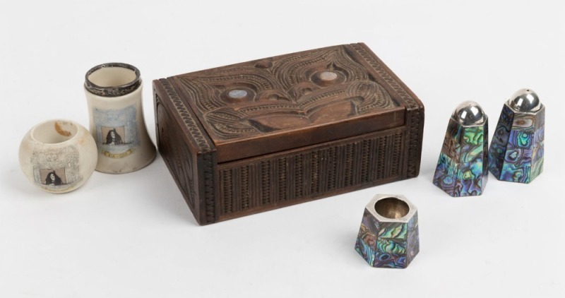 NEW ZEALAND "TAPU" Maori carved box with original paper label, together with an antique ceramic "KIA-ORA" vesta stand and silver rimmed miniature vase both adorned with female Maori portrait and decoration, plus a three piece silver and paua shell condime