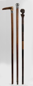 GEORGE ADAMS - TATTERSALLS: antique walking stick with carved antler handle, silver collar engraved with ownership details, timber shaft and metal ferrule; together with an African timber walking stick with carved head handle and specimen wood segmented shaft, (missing ferrule); and an antique silver topped walking stick with affixed label stating it belonged to C.P. HARRIS of the Bank of N.S.W. (3 items), the largest 88cm high