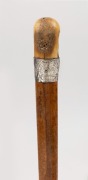 GEORGE ADAMS - TATTERSALLS: antique walking stick with carved antler handle, silver collar engraved with ownership details, timber shaft and metal ferrule; together with an African timber walking stick with carved head handle and specimen wood segmented - 3