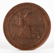 MEDAL: 1879 SYDNEY INTERNATIONAL EXHIBITION large bronze medal by Wyon (76mm), unnamed. This is a large bronze prize medal featuring a view of the Sydney Garden Palace Exhibition Building with a figure of New South Wales standing in front holding the colo