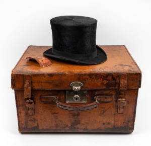 An antique top hat in original red silk lined leather travel case, 19th century, the hat bearing label "D. BUZOLICH, 'THE HAT SPECIALIST', RAILWAY BUILDINGS, FLINDERS & SWANSTON STS.", ​​​​​​​the case 48cm wide