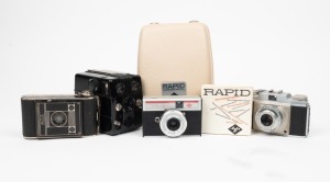 AGFA: Group of four cameras - one c. 1934 Billy Clack 51, one c. 1936 black Bakelite Trolix, one c. 1953 type 1 Silette, and one c. 1971 Rapid-Modell with unusual transparent back in maker's case with instruction booklet. (4 cameras)