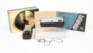 MINOX: Minox B subminiature camera [#931226], c. 1960s, in chrome with Complan 15mm f3.5 lens. Presented in maker's box together with two instruction booklets, brown leatherette case and chain, and Minox Model B Flash Gun accessory in brown leatherette ca