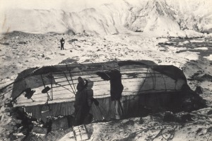 FRANK HURLEY: "Twenty Two Men Of The Expedition Lived Under These Boats On Elephant Island For Four And A Half Months, Awaiting Rescue." vintage silver gelatin photograph, 15 x 20cm, laid down on grey card, numbered "9" in the top right corner and titled 