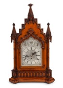 An antique English Gothic Revival mantle clock in carved oak case with three train fusee movement, quarter chiming on nest of nine bells, attractively engraved one-piece silvered dial with three subsidiary dials to the arch, 19th Century, an imposing 78 c