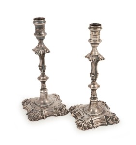 A fine pair of solid cast sterling silver candlesticks with engraved crests, made in London, circa 1765, 24cm high, 1038 grams total