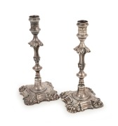 A fine pair of solid cast sterling silver candlesticks with engraved crests, made in London, circa 1765, 24cm high, 1038 grams total