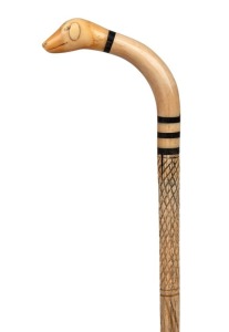 An antique walking stick with whale's tooth and baleen handle carved in the form of a dog's head, on a turned whalebone shaft, 19th century, 93cm high