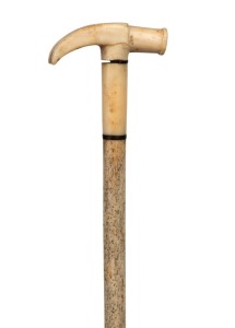 An antique walking stick with whale's tooth handle carved in the form of a hammer head with baleen spacers and whalebone shaft, 19th century, 82cm high