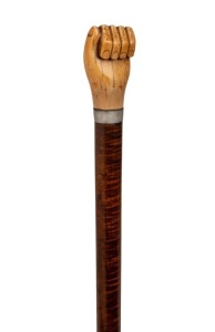 An antique walking stick with carved fist whale's tooth handle, silver collar, on a fiddleback blackwood shaft with metal ferrule, 19th century, 93cm high