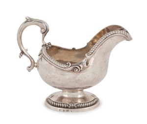 A fine quality Georgian cast sterling silver Rococo sauce boat with engraved griffin crest, maker's marks illegible, made in London, circa 1767, 16cm high, an impressive 556 grams