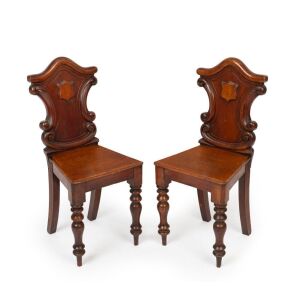 A pair of antique Australian cedar hall chairs with shield medallion insert backs, 19th century, 92cm high