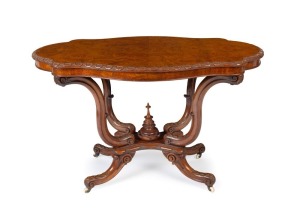 A fine quality antique Irish burr walnut shaped centre table with attractively carved undercarriage on original brass castors, circa 1875, 72cm high, 113cm wide, 70cm deep