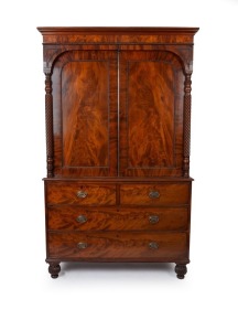 An antique Scottish linen press with finely figured panel doors flanked by quilled and turned columns above three graduated drawers, standing on finely turned and quilled bun feet, circa 1830. Note: Linen slides absent. The upper section now converted to 
