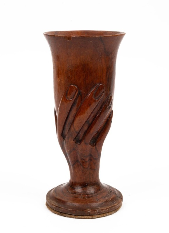 An antique carved wooden hand cup, stamped "A SOUVENIR FROM PITCAIRN ISLAND", ​​​​​​​19.5cm high