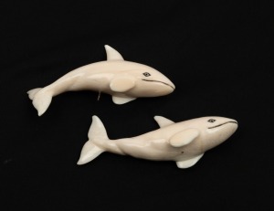 Two carved marine ivory whale ornaments, 20th century, the larger 10.5cm long