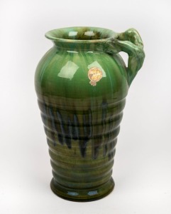 REMUED green glazed pottery vase with branch handle, incised "Remued" and bearing original foil label, 26cm high