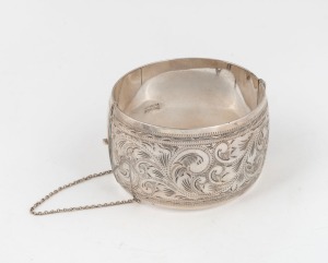An engraved sterling silver bangle, 20th century, stamped "Scandia, Sterling"