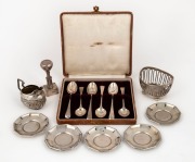 A German 800 silver cream jug, set of six 800 silver dishes, a sterling silver basket, a set of six sterling silver teaspoons and a sterling silver stamp press, 19th and 20th century, (15 items), ​​​​​​​285 grams total