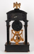 An antique Viennese mantle clock in ebonized Empire architectural case with alabaster columns and water gilt capitals plus griffins and eagle finial. 30 hour quarter gong striking movement with silk suspension and finely engine turned dial, circa 1840, 76 - 5