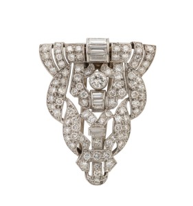 An Art Deco platinum lapel brooch, pave set with brilliant and baguette cut white diamonds, circa 1930, 3.5cm wide, 10.9 grams total