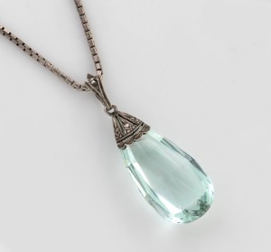 An aquamarine pendant mounted in silver and marcasite, suspended on a sterling silver chain, 20th century, the pendant 3.5cm high including loop, the chain 38cm long