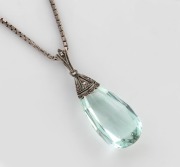 An aquamarine pendant mounted in silver and marcasite, suspended on a sterling silver chain, 20th century, ​​​​​​​the pendant 3.5cm high including loop, the chain 38cm long