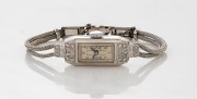 An Art Deco 18ct white gold and diamond encrusted lady's wristwatch circa 1930, case stamped "HANDLEY, 18C."