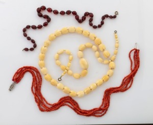Four vintage bead necklaces including ivory, coral and plastic, the coral example 44cm long
