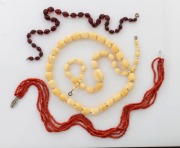Four vintage bead necklaces including ivory, coral and plastic, ​​​​​​​the coral example 44cm long