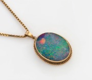 A 9ct yellow gold mounted opal pendant, suspended on a 9ct gold chain, the pendant 3.5cm high including loop, the chain 5.8 grams