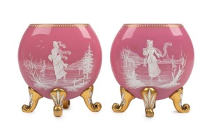 A pair of antique Bohemian pink glass mantle vases adorned with ice skating figures in white enamel with gilded highlights, 19th century, 15.5cm high