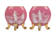 A pair of antique Bohemian pink glass mantle vases adorned with ice skating figures in white enamel with gilded highlights, 19th century, 15.5cm high