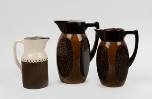 Three vintage ceramic jugs, two with silver plated lids, 20th century, the largest 24cm high