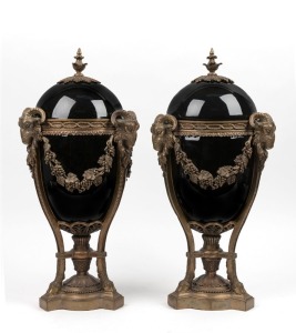 A pair of French Empire Revival reproduction lidded black porcelain urns with cast metal mounts, 20th century, 50cm high