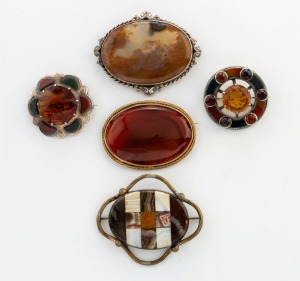 Five assorted Scottish agate and carnelian brooches with sterling silver and gilt metal mounts, (two set with faceted cut stones) 19th/20th century, the largest 7cm wide