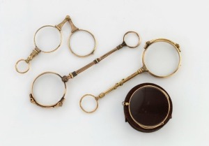 Three antique lorgnettes, one with snake decoration and ruby set eyes, together with an antique monocle in leather pouch, 19th century, (4 items), the largest 14cm long
