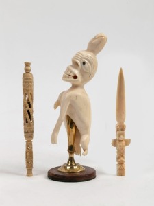 Inuit carved marine ivory spirit figure (with later stand); together with a totem style paper knife and an antique carved whalebone pen, 19th century, (3 items), the spirit figure 15cm high