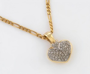 A 9ct yellow and white gold heart shaped pendant, pave set with brilliant cut white diamonds, suspended on an 18ct yellow gold chain, the pendant 3cm high overall and 6.3 grams, the chain 46cm long 13.9 grams