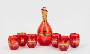 An Italian ruby glass decanter set with gilt overlay decoration, 20th century, (7 items), the decanter 23cm high