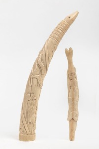 Two African carved ivory ornaments, the larger 30cm long
