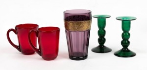 A pair of vintage green glass candlesticks, together with a pair of ruby glass mugs, and an amethyst glass vase with gilt border in the Moser style, 20th century, the largest 16cm high