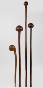 Four assorted wooden clubs including Zulu knobkerrie​​​​​​​, the largest 101cm long