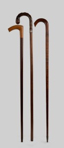 Three antique and vintage walking sticks with fiddleback blackwood and snakewood shafts, 19th and 20th century, the largest 100cm high