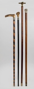 Four assorted antique and vintage walking sticks including an unusual parquetry segmented example, silver topped Malacca cane example, ebony shaft example and snakewood example with brass fist handle, 19th and 20th century, the largest 106cm high