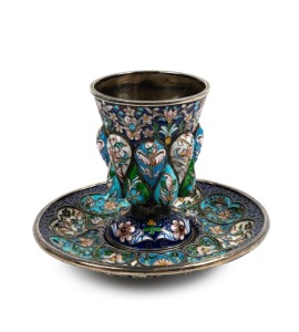 A high quality ornate silver and enamel cup and saucer, Russian or Scandinavian, stamped "NC84", the cup 7cm high, 262 grams total