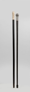 An antique walking stick with engraved silver top and palm wood shaft, together with a Japanese carved bone and ebony shaft example with metal ferrule, 19th century, (2 items), the larger 89cm high